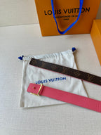 Pink leather belt strap and dark monogram belt piece in white drawstring pouch