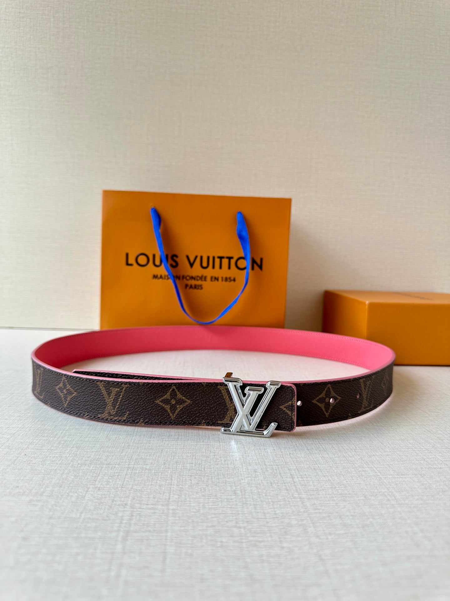 Louis Vuitton belt: dark monogram canvas with silver LV buckle and pink strap