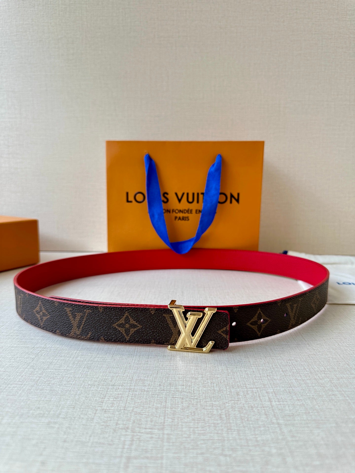 Louis Vuitton monogram belt with red interior and silver LV buckle