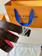 Louis Vuitton monogram belt with silver LV buckle and red interior, angled