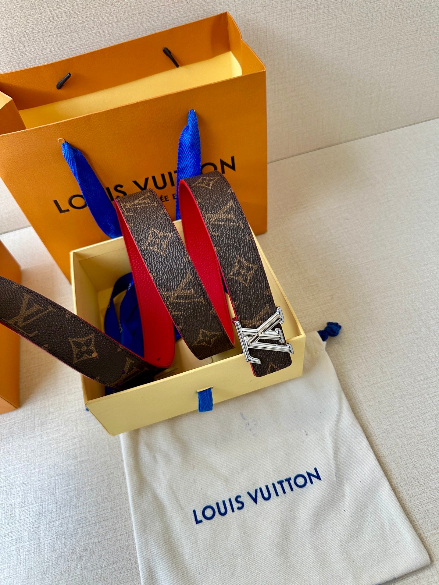 Louis Vuitton monogram belt with red lining and silver LV buckle in gift box