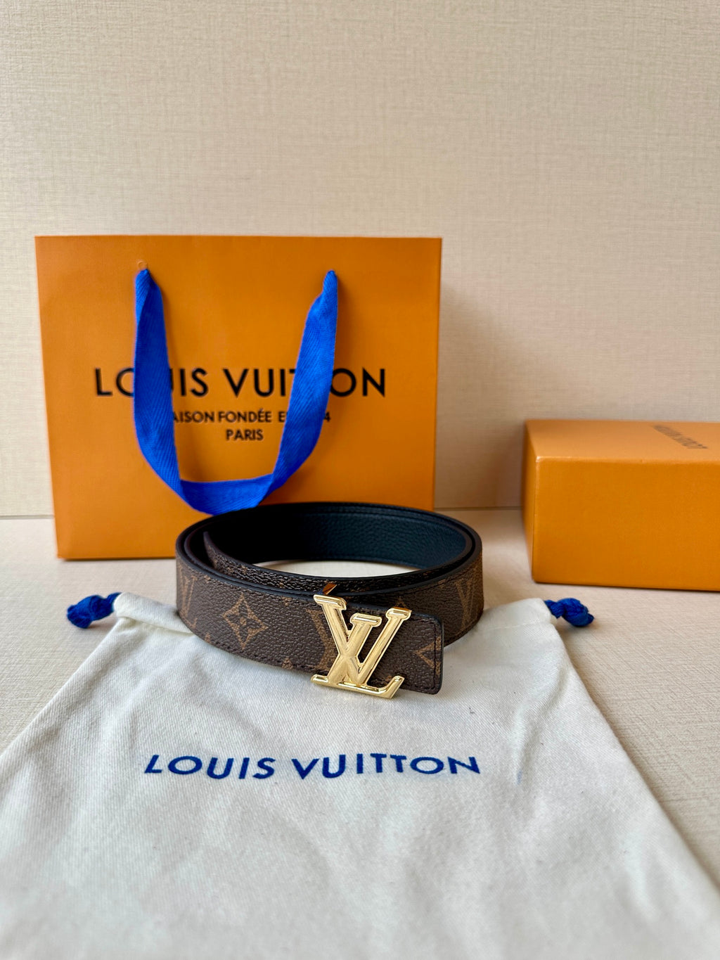 Brown monogram Louis Vuitton-style belt with gold-tone LV center buckle