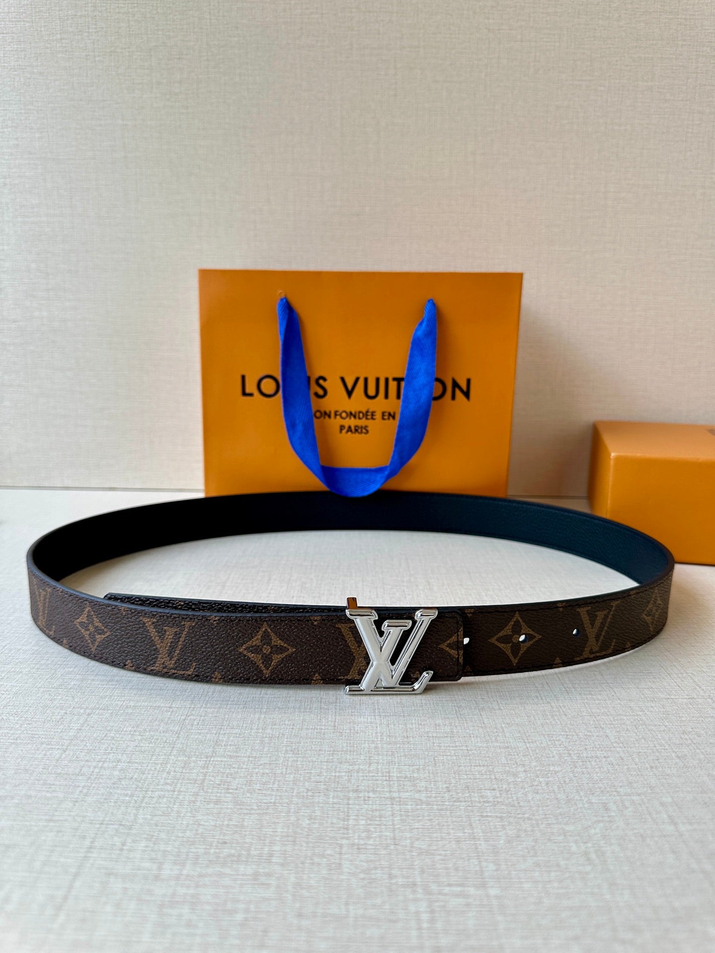 Brown monogram belt with dark edge and gold-tone LV buckle