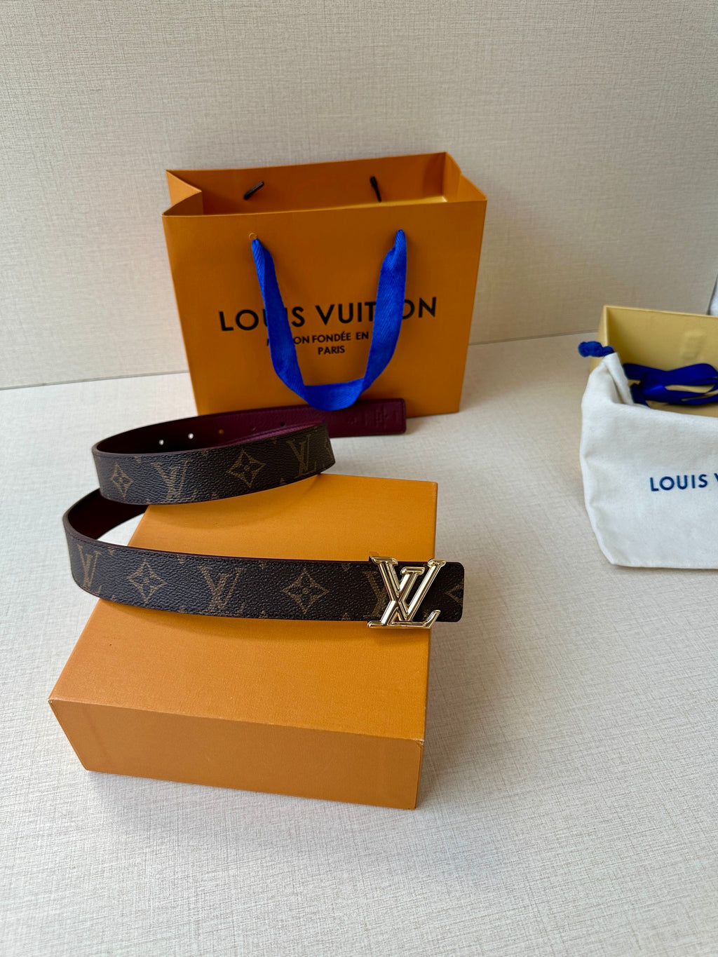 Louis Vuitton monogram belt with silver-tone buckle and burgundy lining