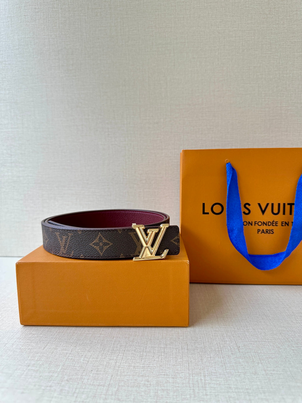 Louis Vuitton monogram belt with gold-tone LV buckle and burgundy lining