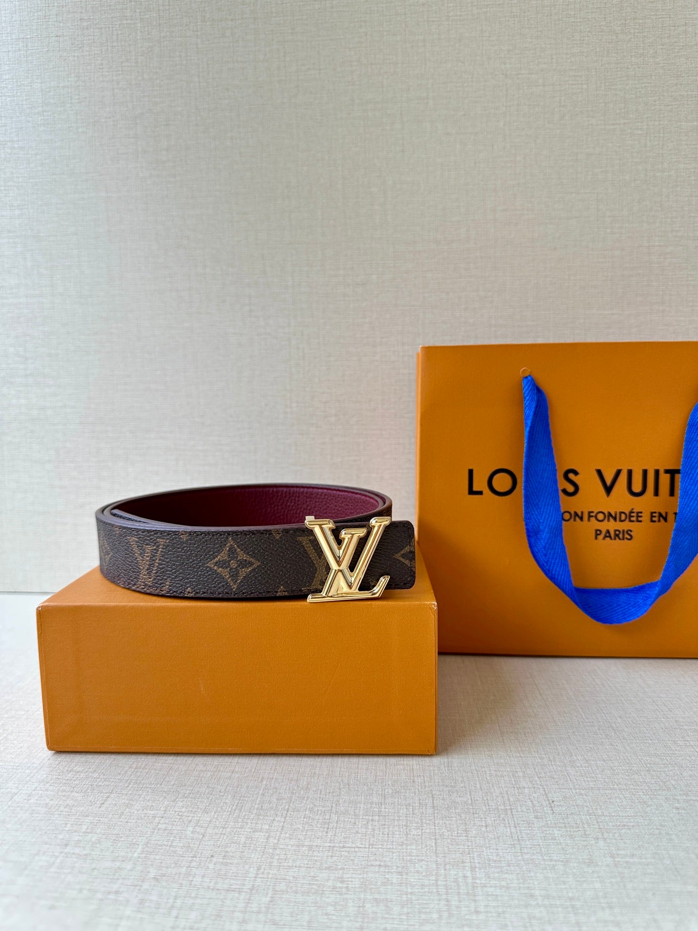 Louis Vuitton monogram belt with gold-tone LV buckle and burgundy lining