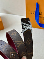 Louis Vuitton monogram belt close-up with silver buckle and burgundy underside