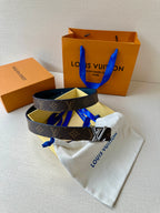 Monogram belt with gold LV buckle on dark strap