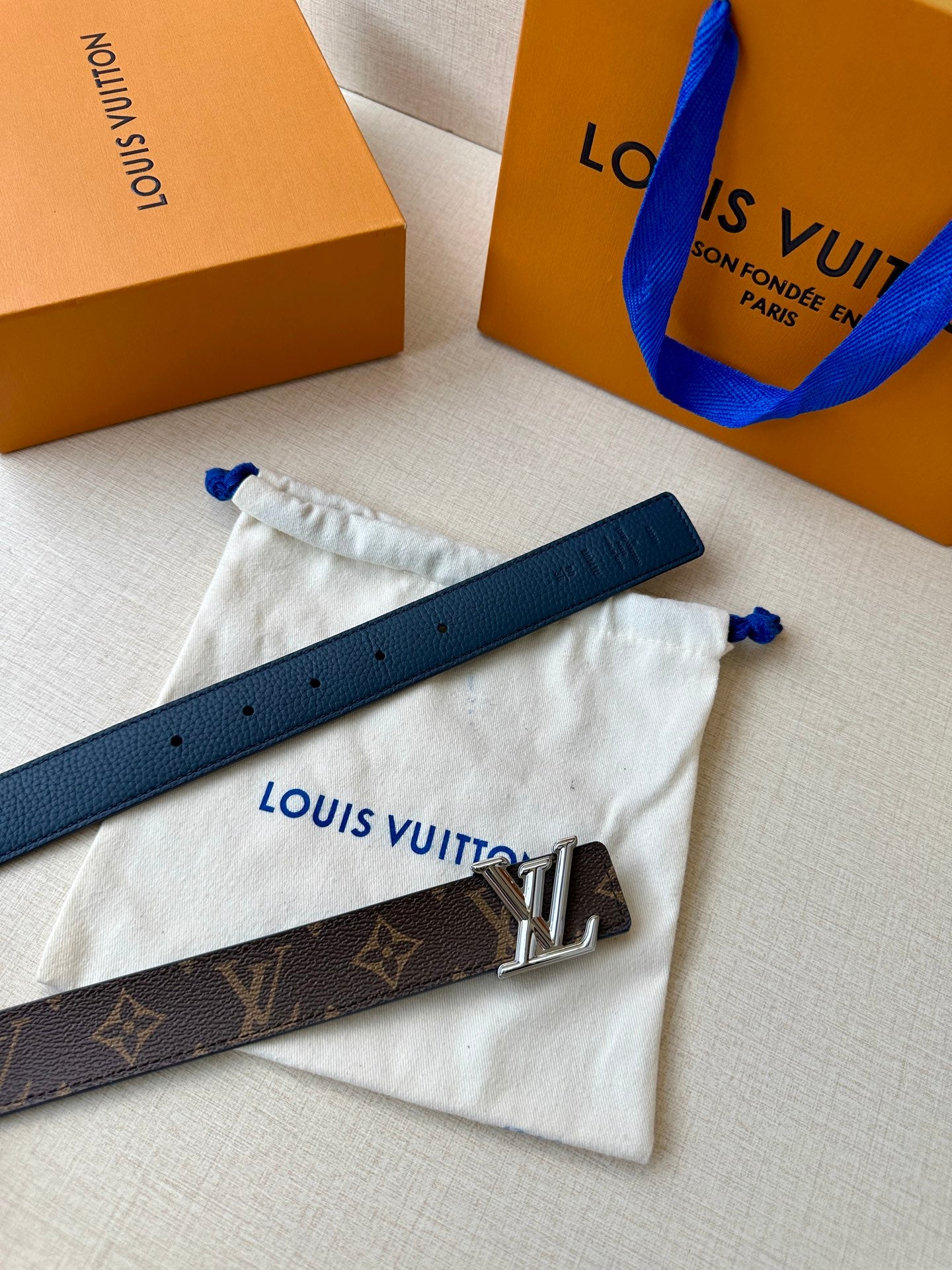 Monogram belt with gold LV buckle, dark strap with adjustment holes
