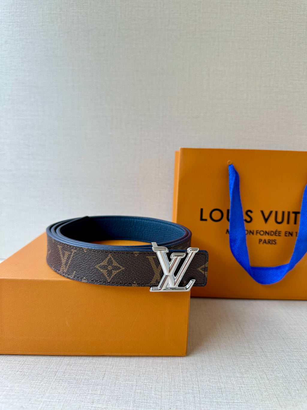 Monogram belt with gold LV buckle on dark patterned strap