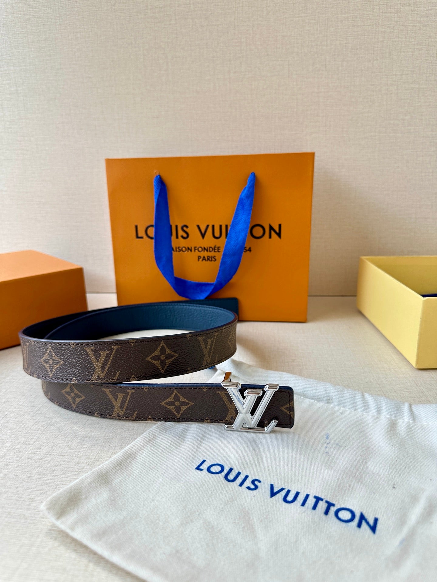 Monogram belt with gold LV buckle on dark patterned strap