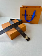 Monogram belt with gold LV buckle, dark strap shown laid out