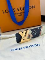 Monogram leather belt with gold-tone LV buckle on multicolor patterned strap.