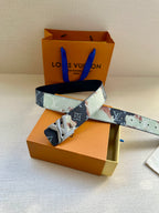 Two-tone monogram belt with gold-tone LV buckle on patterned leather strap.