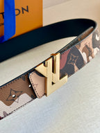 Monogram belt close-up with gold buckle and patterned leather strap