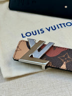 Monogram belt buckle close-up with metal clasp on patterned strap