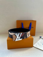 Monogram canvas belt with gold-tone buckle on orange gift box