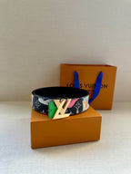 Multicolor belt with black base, gold buckle, and colorful graphic pattern