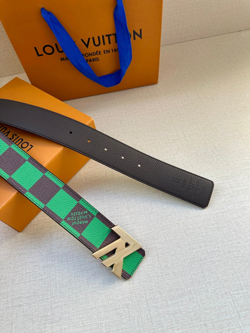 Louis Vuitton belt with black leather strap, green check strap and gold-tone buckle detail