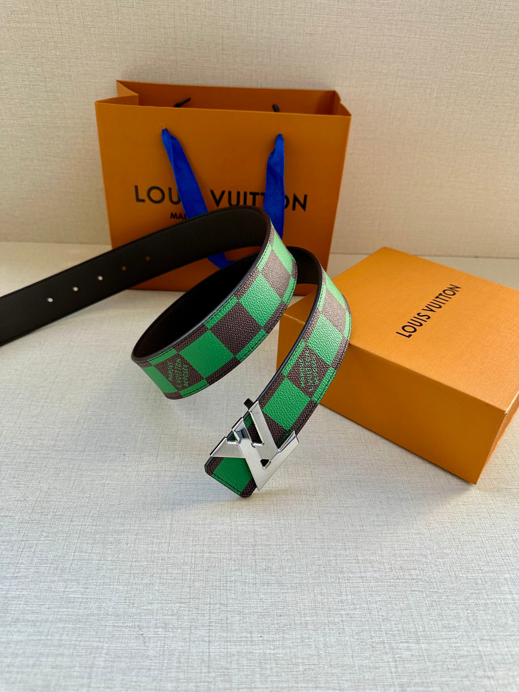 Louis Vuitton belt with black leather band, green check pattern and silver buckle