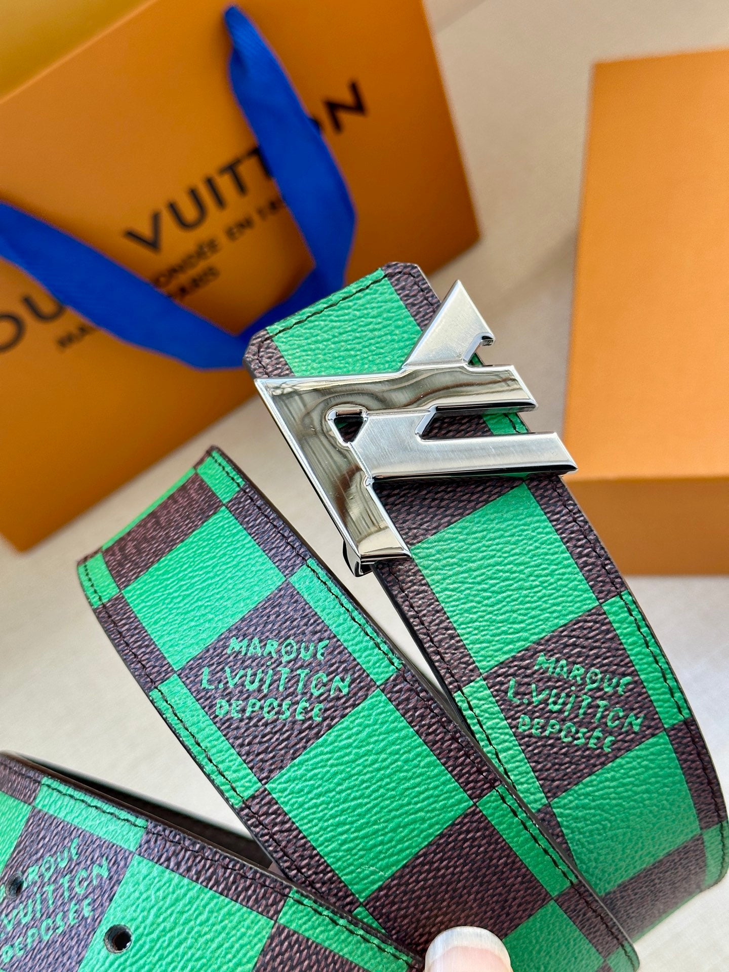 Louis Vuitton belt with green check strap and large silver buckle