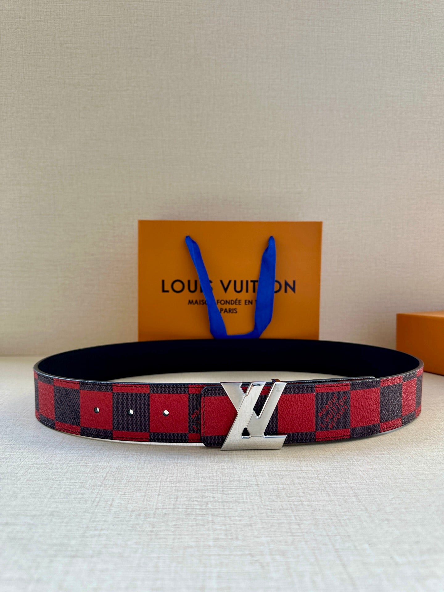 Louis Vuitton belt with red and black check strap and gold LV buckle