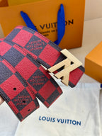 Louis Vuitton belt detail with red plaid strap and gold LV buckle hardware