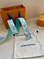 Turquoise belt strap with gold-tone LV buckle and logo pattern, shown with pouch