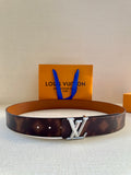 Louis Vuitton belt in dark brown leather with silver-tone LV buckle.