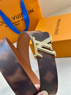 Close-up of dark brown leather belt with silver-tone LV buckle.