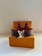 Designer belt in dark brown leather with silver-tone LV buckle and keeper holes.