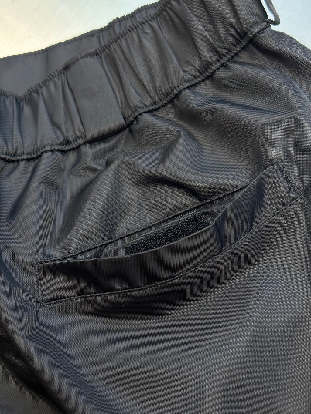 Prada re-nylon cargo shorts, dark black, curved flap pocket detail