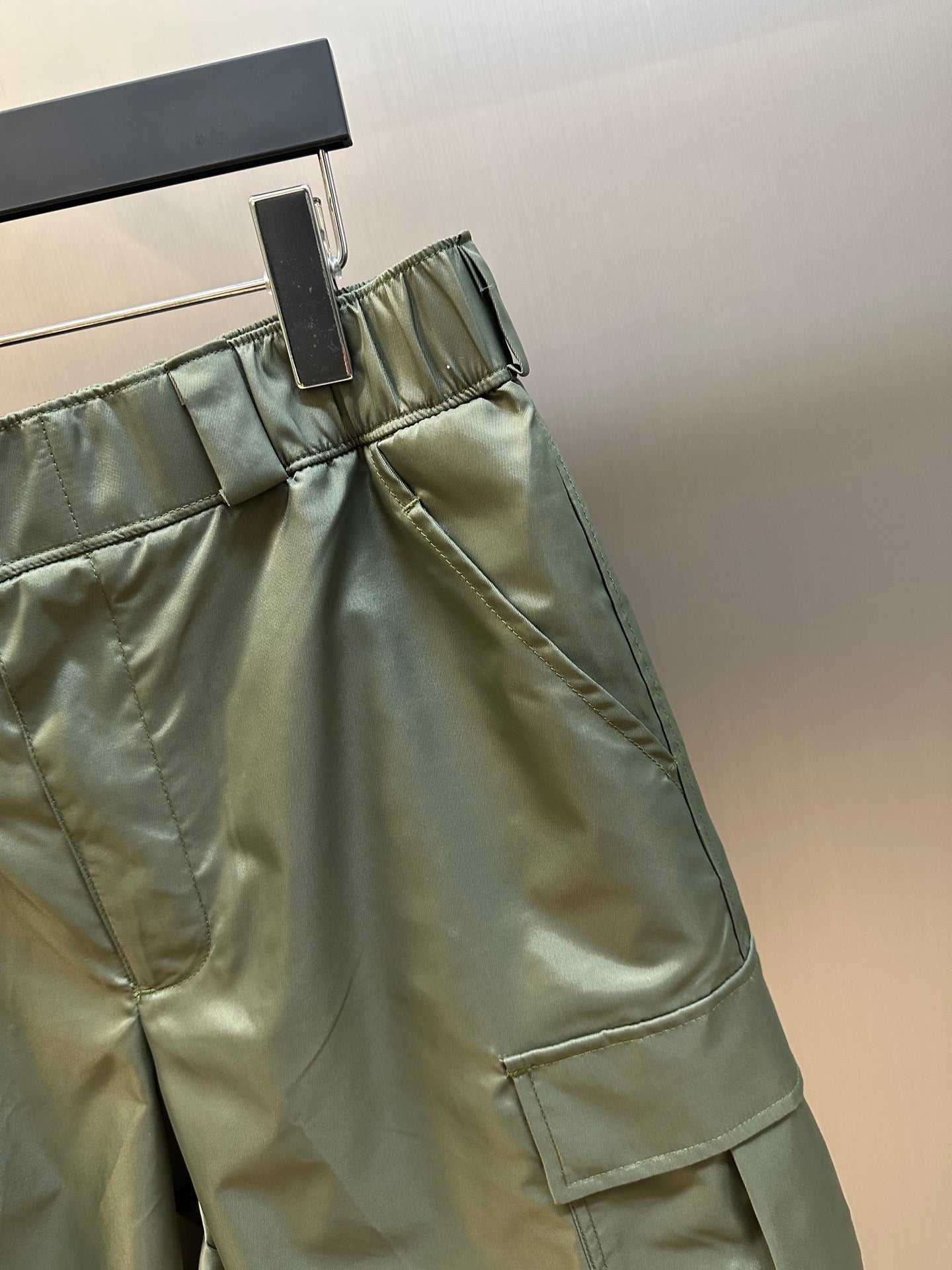 Prada cargo shorts close-up with drawstring waistband and stitched slanted pocket