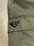 Prada cargo shorts close-up with PRADA logo label on side pocket flap