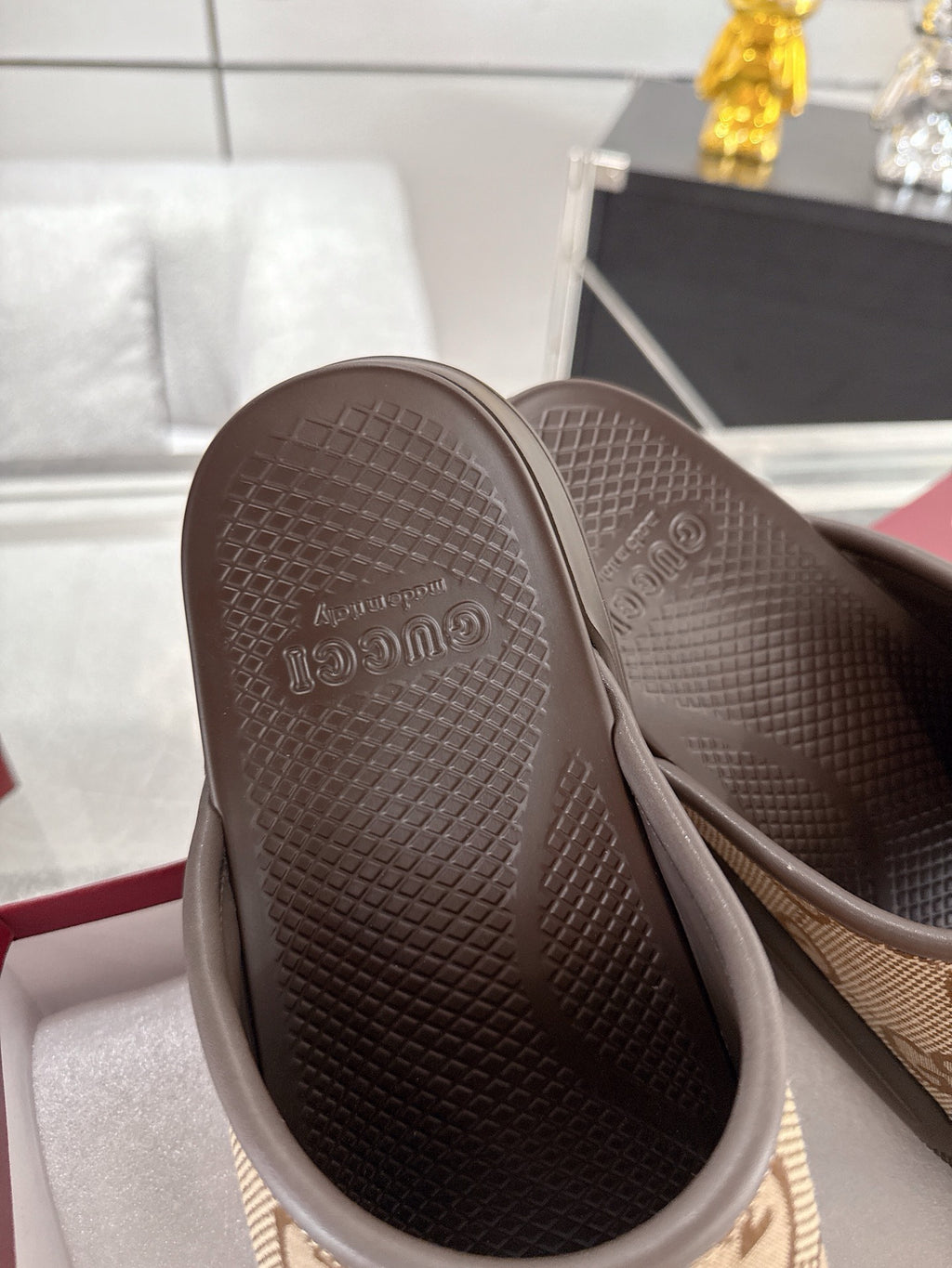 Gucci slide sandal outsole view with textured dark rubber tread