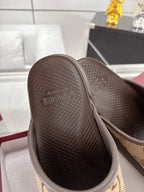 Gucci slide sandal outsole view with textured dark rubber tread