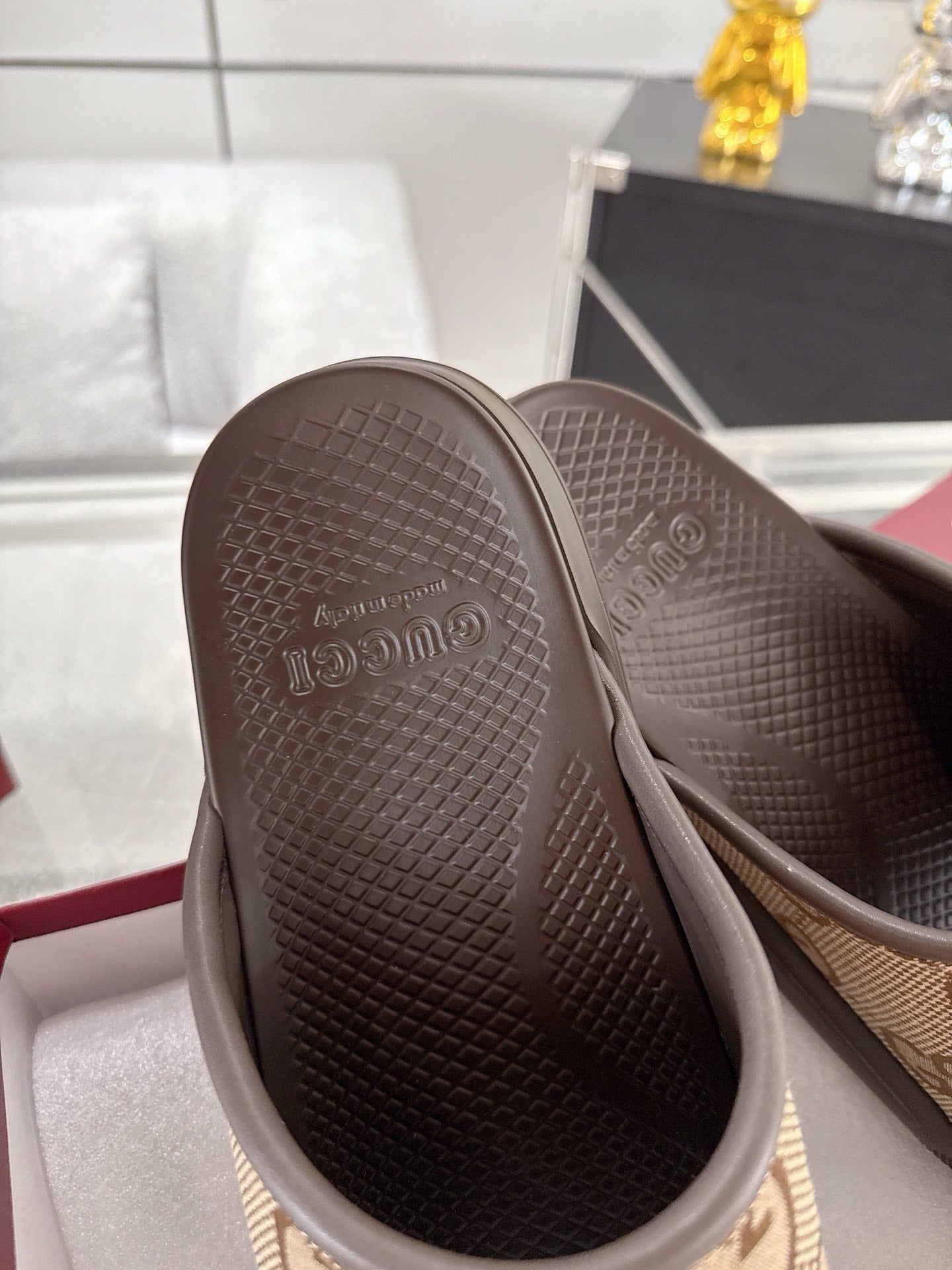 Gucci slide sandal outsole view with textured dark rubber tread