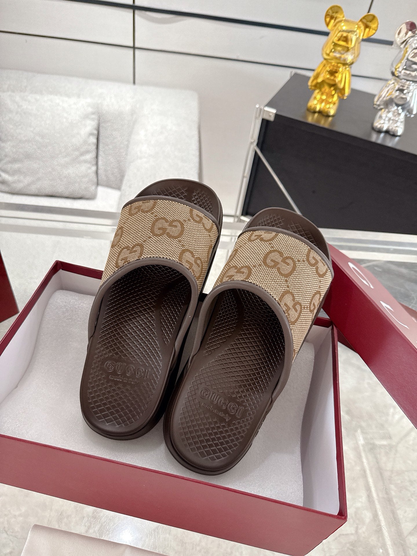 Gucci GG canvas slide sandals with dark brown soles and straps