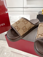 Gucci GG canvas slide sandals, tan monogram straps over dark footbed