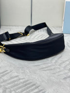 Prada crescent crossbody bag in dark navy with gold chain strap and adjustable belt