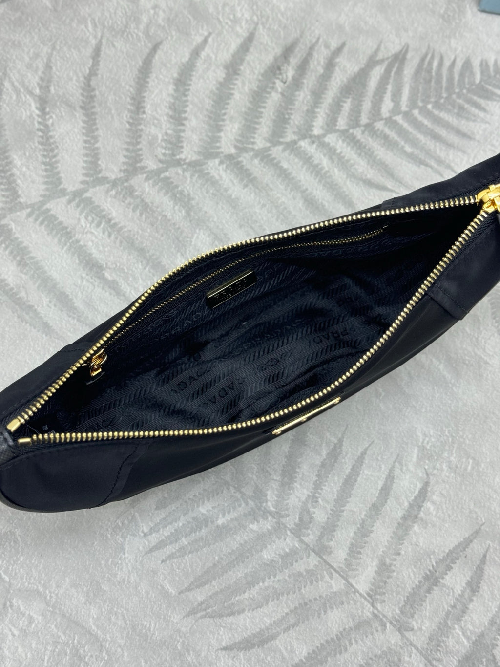 Prada crescent hobo bag interior with gold zipper trim and dark navy lining
