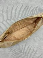Beige shoulder bag interior view with zip opening and patterned lining