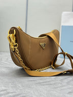 Prada tan leather hobo bag with gold chain strap and triangular front logo badge.