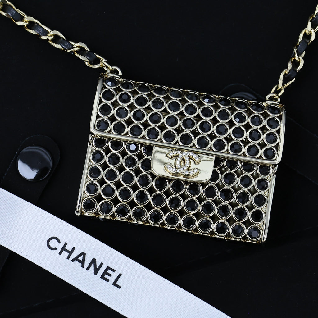 Chanel mini flap bag with navy ring-mesh panels, gold chain strap and crest clasp