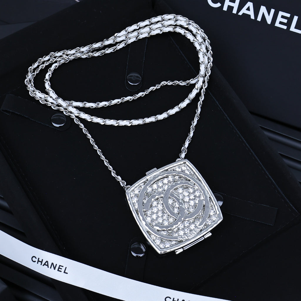 Silver-tone rhinestone square pendant necklace with braided chain and logo tag