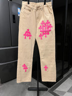 Beige denim pants with pink cross embroidery on legs