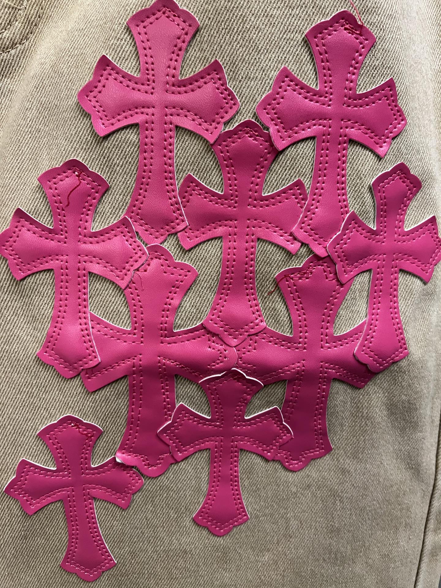Pink cross embroidery appliques on beige denim