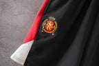 Black pants with embroidered crest logo on the red side stripe