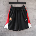 Balenciaga pants with black body, red side panels, and white hem trim