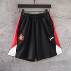Balenciaga pants with black body, red side panels, and white hem trim